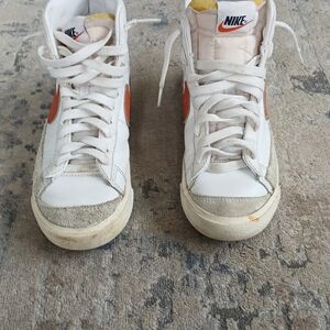 Nike White High-Top Sneakers with Orange Swoosh